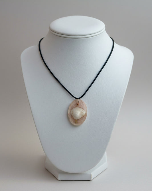 Necklace with a shell pendant on a white background